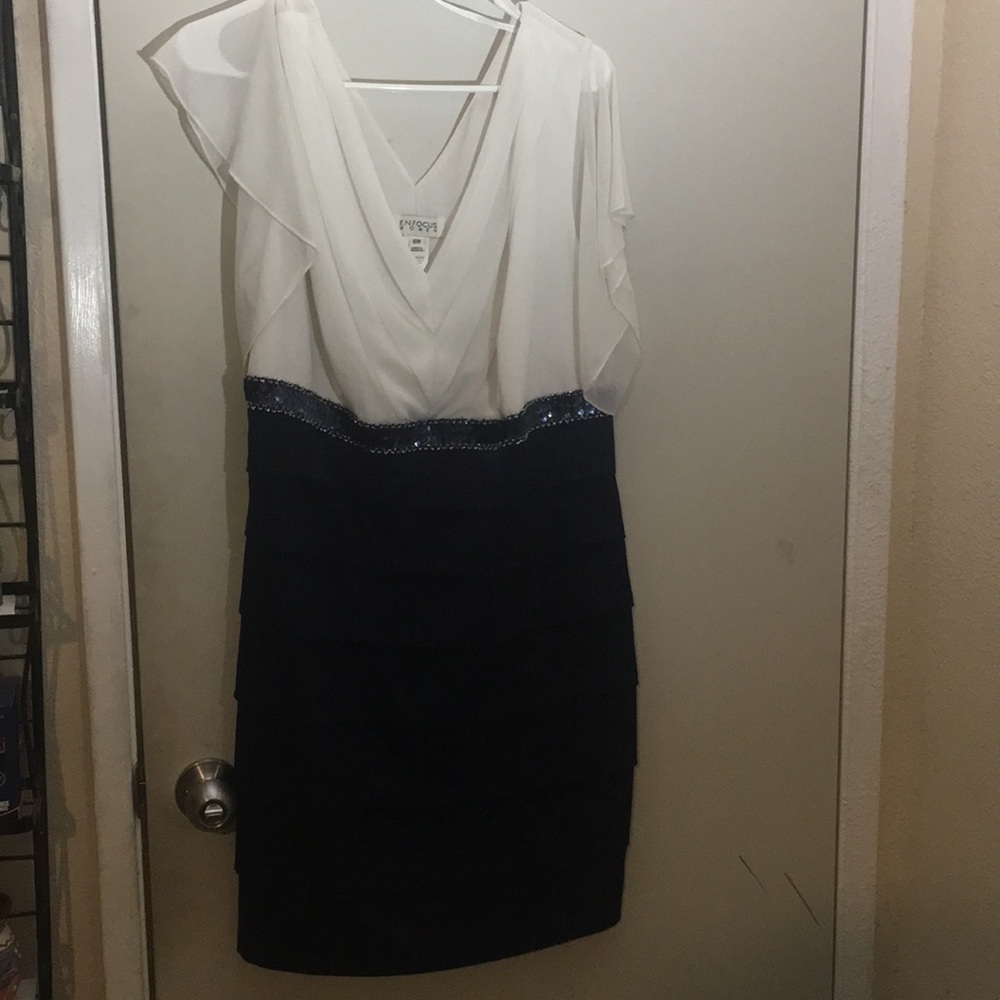 Woman’s navy and cream dress.